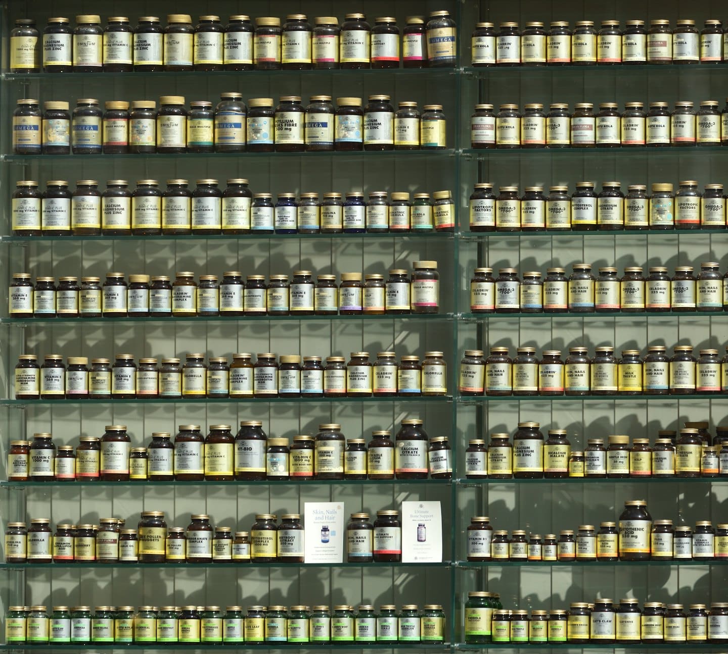 Shelves stocked with many vitamin and supplement bottles.